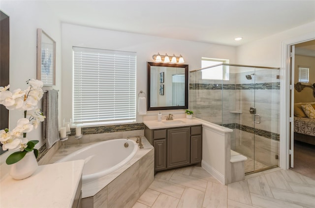 bathroom featuring vanity, tile patterned flooring, and separate shower and tub