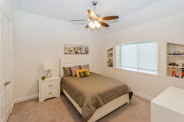 bedroom with ceiling fan and light carpet