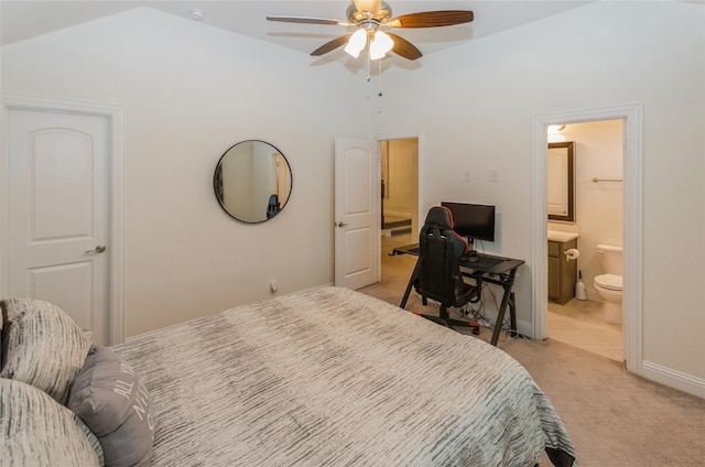 bedroom featuring ceiling fan, ensuite bath, vaulted ceiling, and light carpet