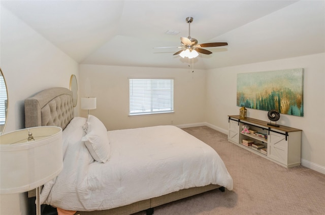 bedroom with lofted ceiling, light colored carpet, and ceiling fan