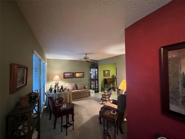 carpeted empty room featuring a textured ceiling and ceiling fan