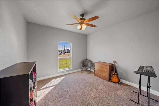 miscellaneous room with ceiling fan and light colored carpet