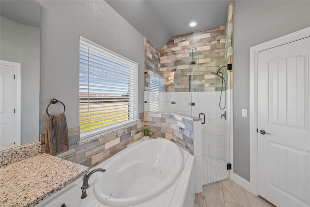 bathroom with lofted ceiling, tile patterned floors, separate shower and tub, and vanity