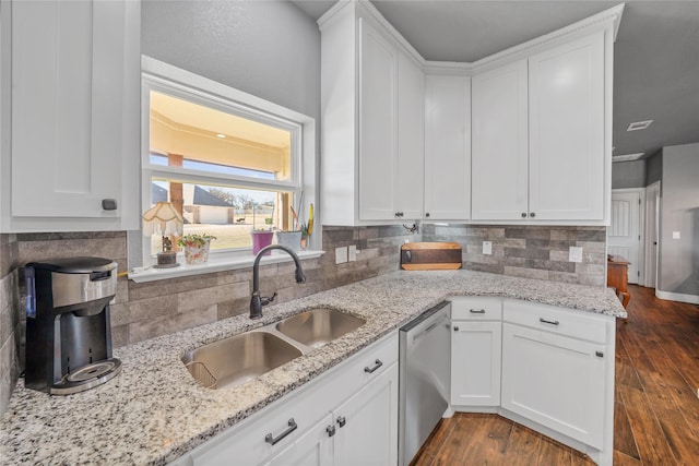 kitchen with sink, white cabinets, dishwasher, and light stone countertops