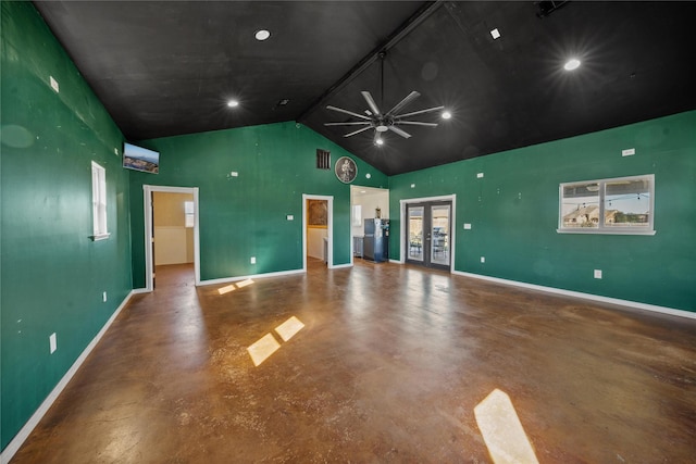 unfurnished room with ceiling fan, french doors, concrete floors, and high vaulted ceiling