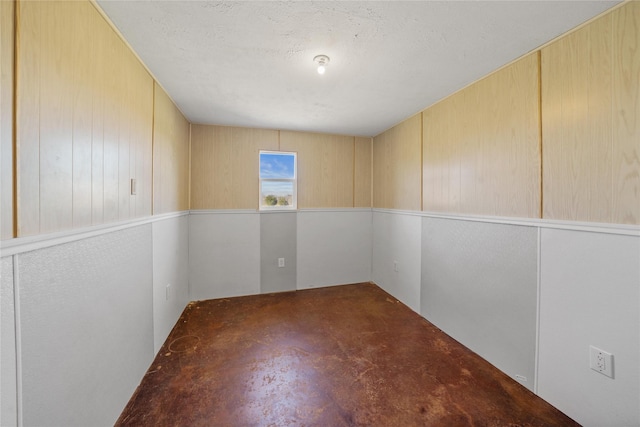 unfurnished room with a textured ceiling