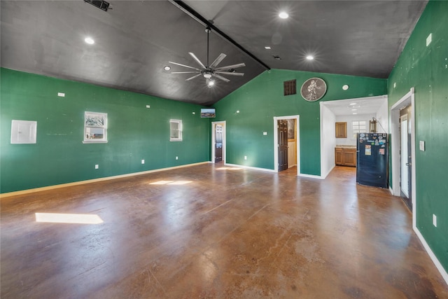 unfurnished living room featuring ceiling fan, concrete floors, and vaulted ceiling