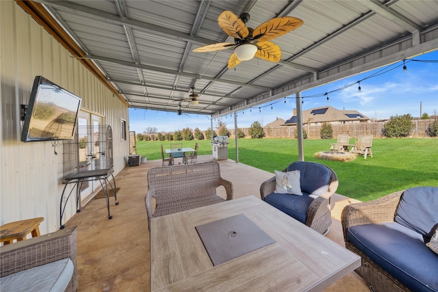 wooden terrace with a lawn, a patio area, ceiling fan, and an outdoor hangout area