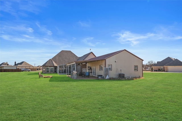 back of house with a patio, central AC, and a lawn