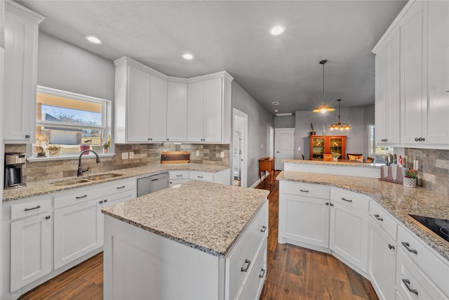 kitchen featuring sink, white cabinets, and pendant lighting