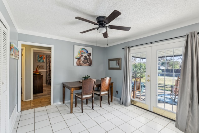 dining area with ceiling fan, french doors, light tile patterned flooring, and a textured ceiling