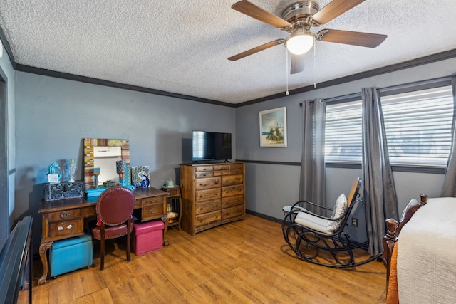 bedroom featuring a textured ceiling, ceiling fan, light hardwood / wood-style floors, and crown molding