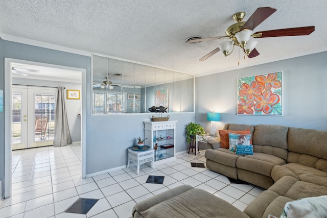 tiled living room featuring french doors and a textured ceiling