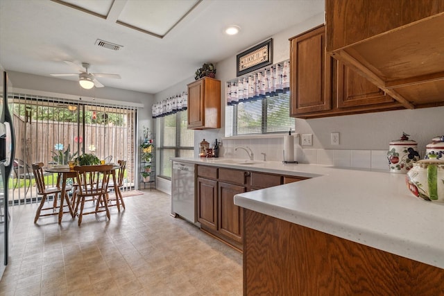 kitchen featuring ceiling fan, dishwasher, and sink