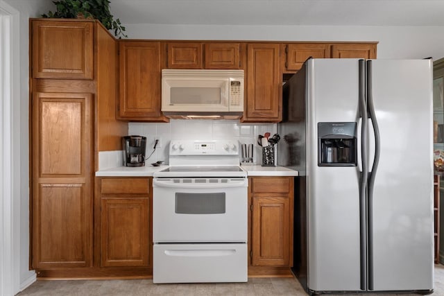 kitchen with white appliances and tasteful backsplash