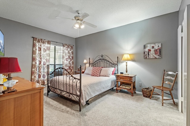 carpeted bedroom with a textured ceiling and ceiling fan