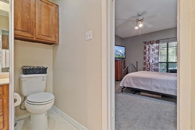 bathroom with toilet, vanity, and ceiling fan