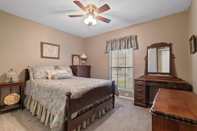 bedroom with a textured ceiling, ceiling fan, and light carpet