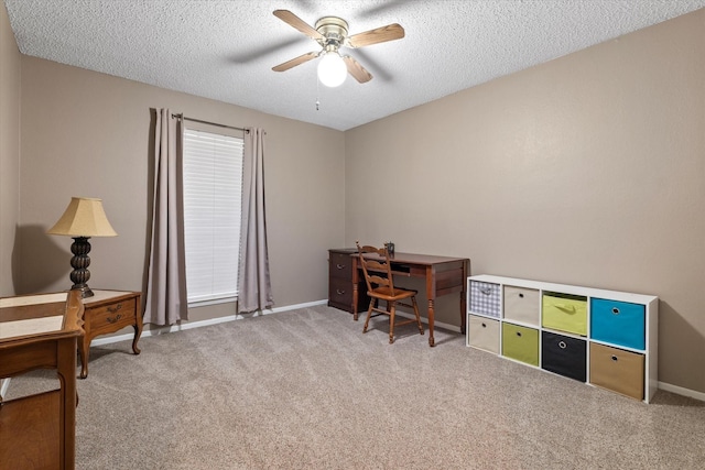 home office featuring light colored carpet, ceiling fan, and a textured ceiling