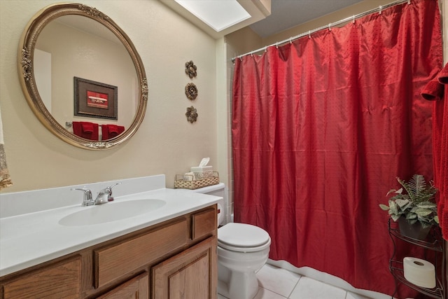 bathroom with toilet, tile patterned floors, and vanity