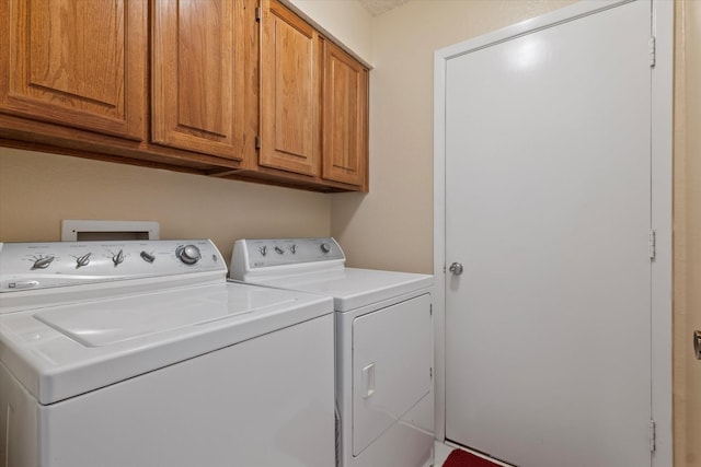 laundry area featuring cabinets and separate washer and dryer