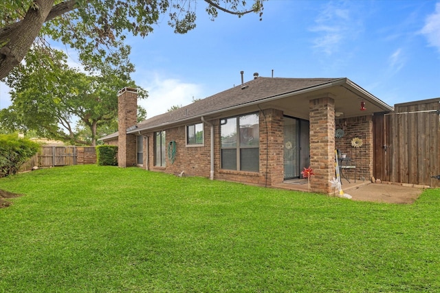 back of house with a yard