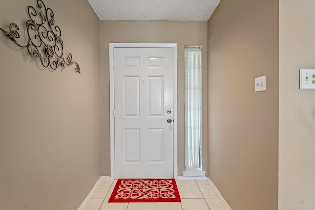 tiled foyer featuring a textured ceiling