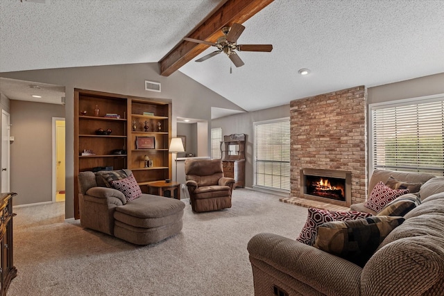 living room featuring a textured ceiling, ceiling fan, a wealth of natural light, and carpet floors