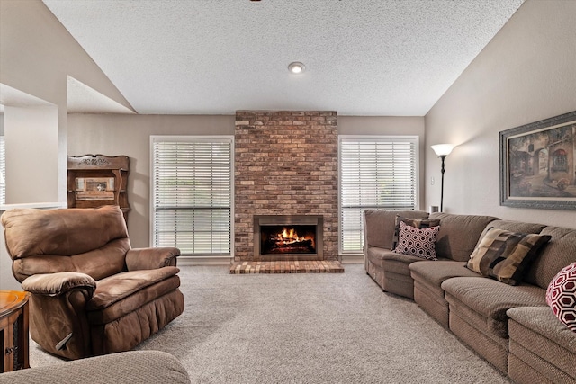 living room featuring lofted ceiling, a brick fireplace, a textured ceiling, and carpet floors