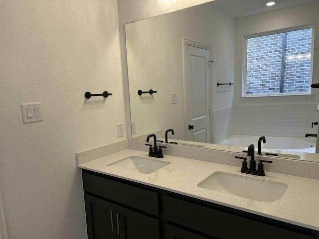 bathroom featuring vanity and a bathing tub