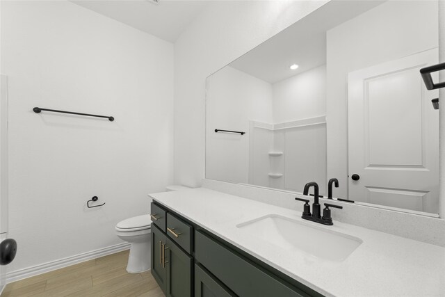 kitchen featuring dishwasher, black stovetop, hanging light fixtures, light wood-type flooring, and sink