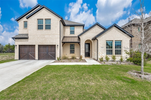 view of front of property featuring a front yard and a garage