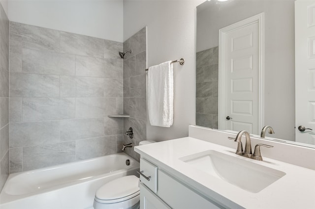 full bathroom with vanity, tiled shower / bath combo, and toilet