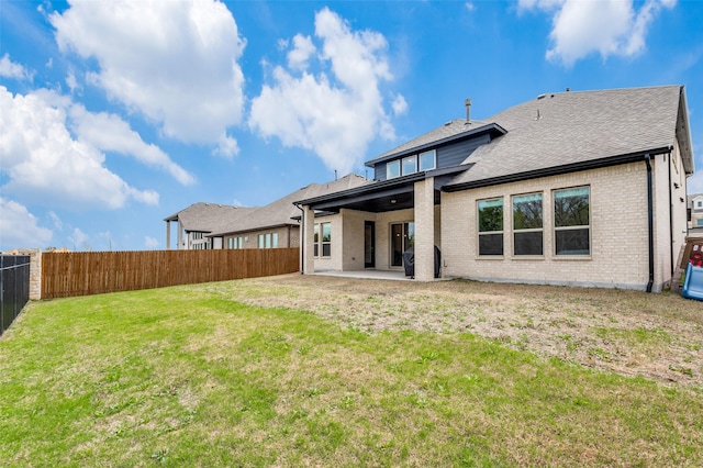 back of property featuring a lawn and a patio