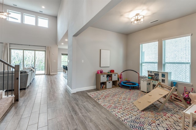 recreation room featuring a wealth of natural light and a notable chandelier