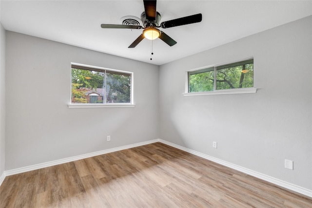 unfurnished room with ceiling fan and light hardwood / wood-style floors