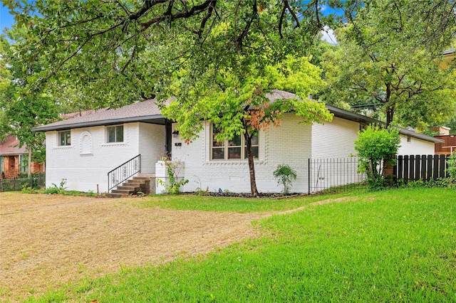 rear view of property with a yard