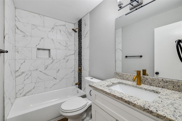 full bathroom featuring toilet, tiled shower / bath, and vanity