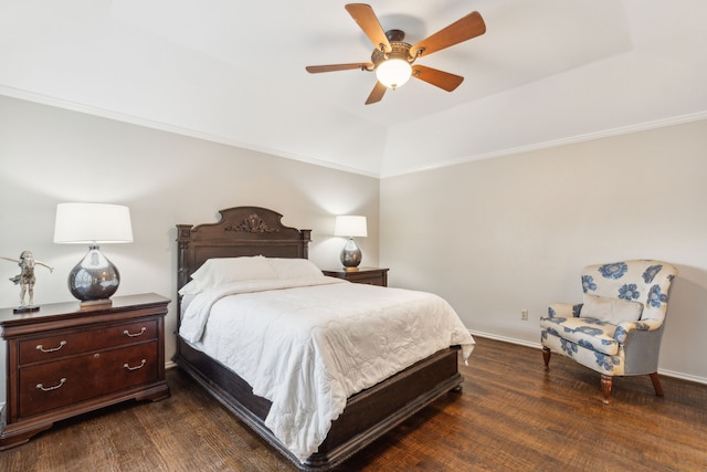 bedroom featuring ceiling fan, dark wood-type flooring, a tray ceiling, and crown molding