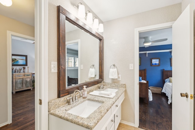 bathroom featuring ceiling fan, hardwood / wood-style floors, and vanity