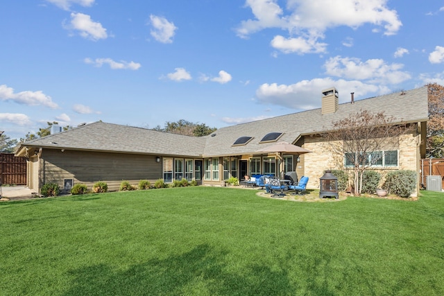 rear view of property with a yard and a patio