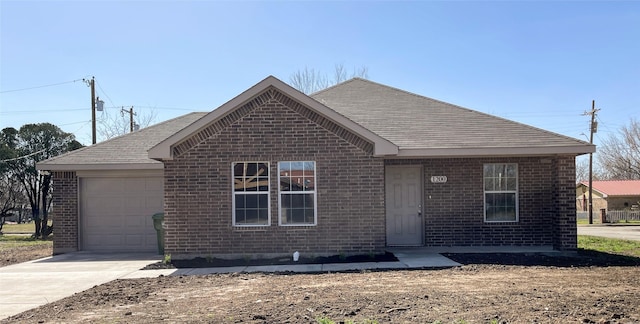 ranch-style home with a garage, brick siding, and concrete driveway