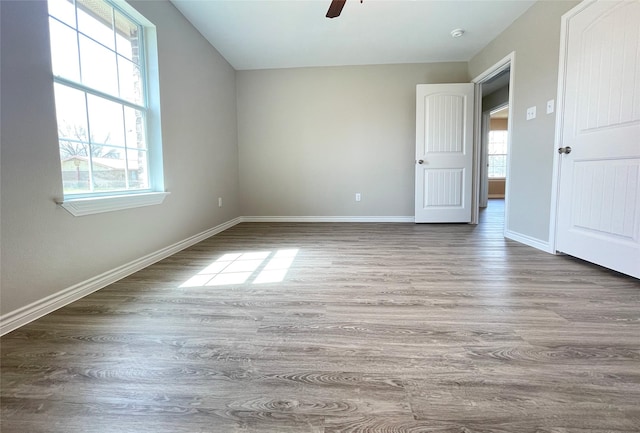 unfurnished bedroom with baseboards, wood finished floors, and a ceiling fan