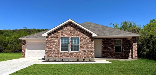 ranch-style home with a front lawn, brick siding, a garage, and driveway