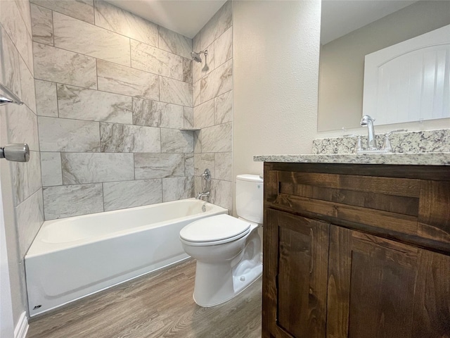 full bath with vanity, toilet, wood finished floors, and shower / bathtub combination