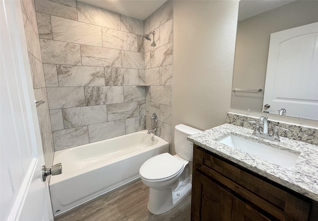 full bath with vanity, bathing tub / shower combination, toilet, and wood finished floors