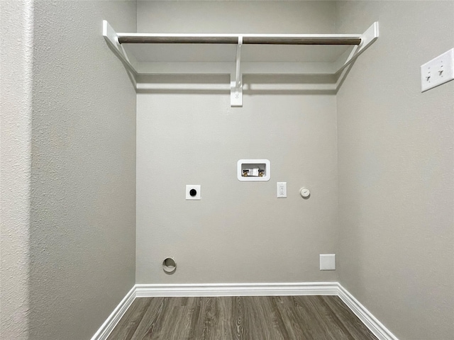 laundry area featuring hookup for a washing machine, baseboards, dark wood finished floors, electric dryer hookup, and hookup for a gas dryer