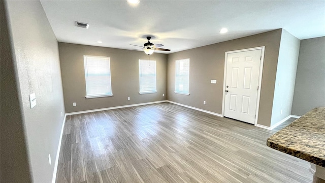 interior space with light hardwood / wood-style floors and ceiling fan