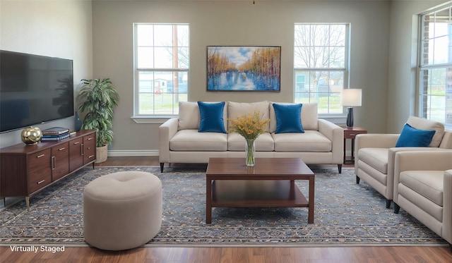 living area with wood finished floors and baseboards