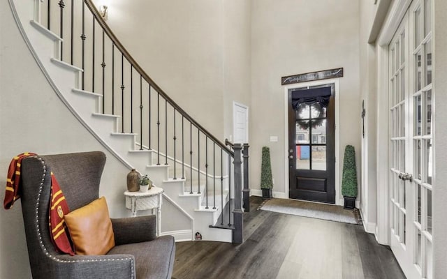 entryway featuring a high ceiling, dark hardwood / wood-style flooring, and french doors